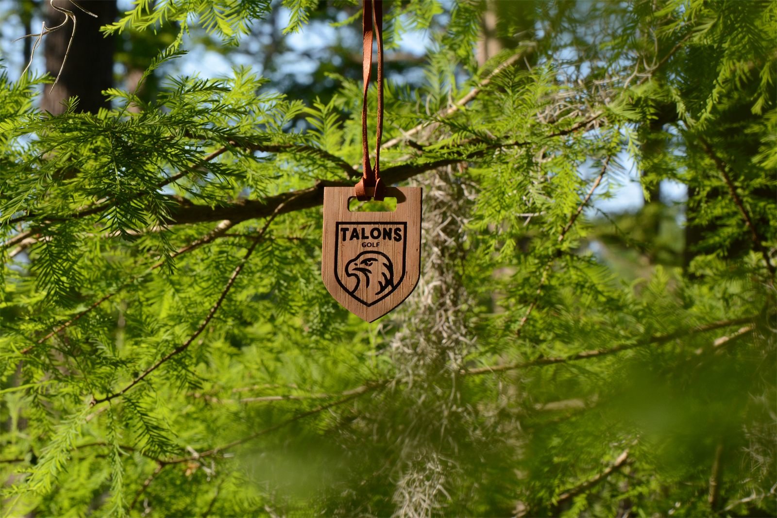 Talons Golf Club wood bag tag hanging outdoors